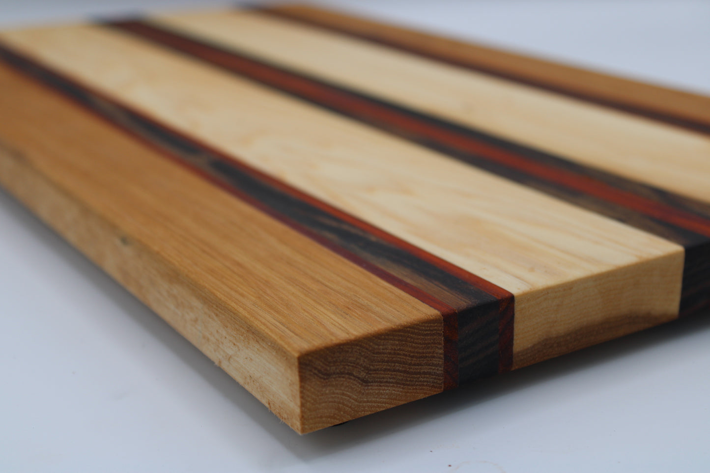 Wooden cutting board with striped pattern on a white background