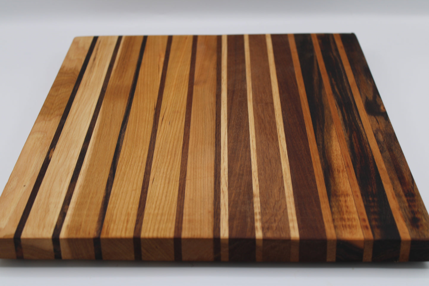 Wooden cutting board with striped pattern on a white background