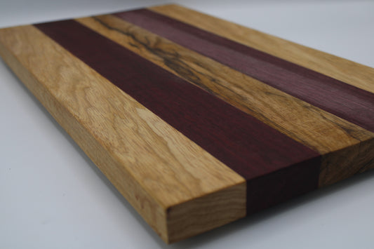Wooden cutting board with purple and brown stripes on a white background