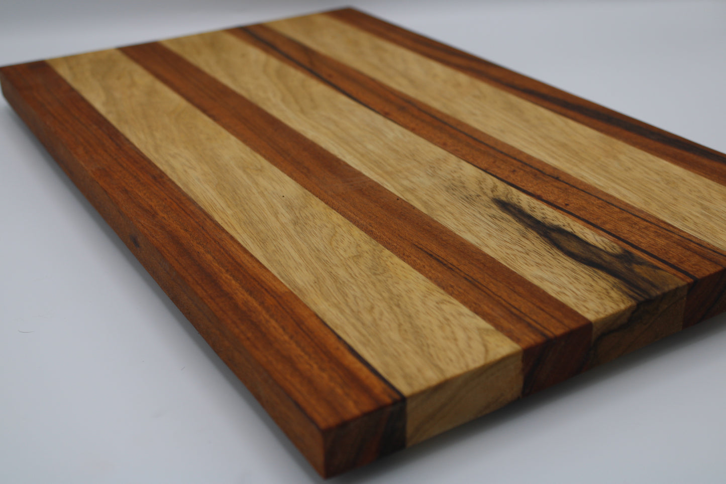 Wooden cutting board with a striped pattern on a white background