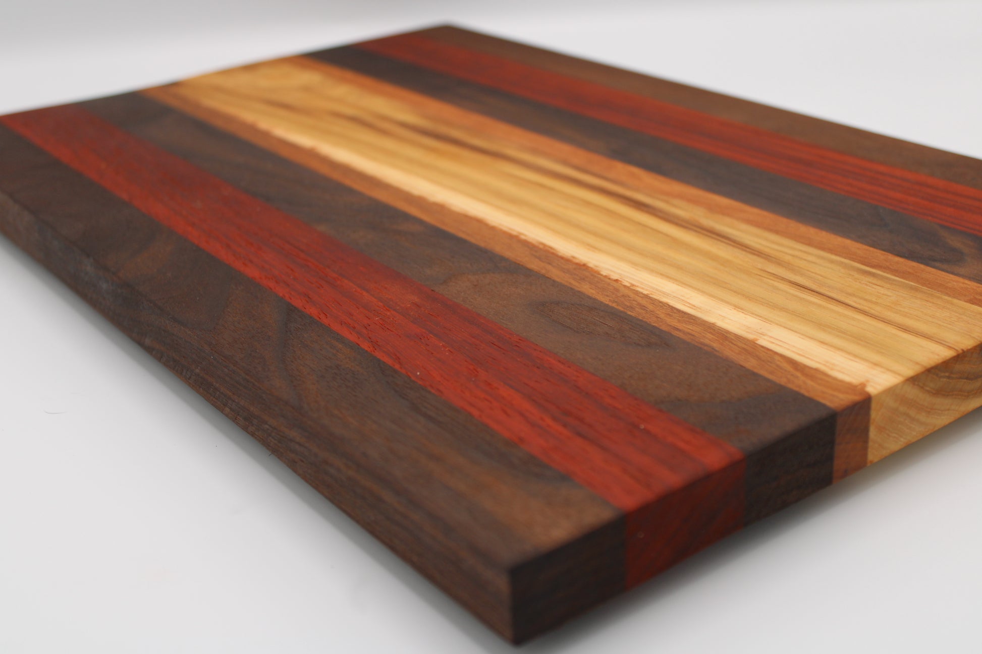 Wooden cutting board with striped pattern on a white background