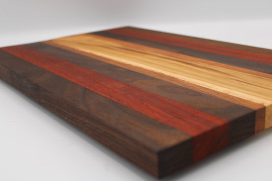 Wooden cutting board with multicolored stripes on a white background