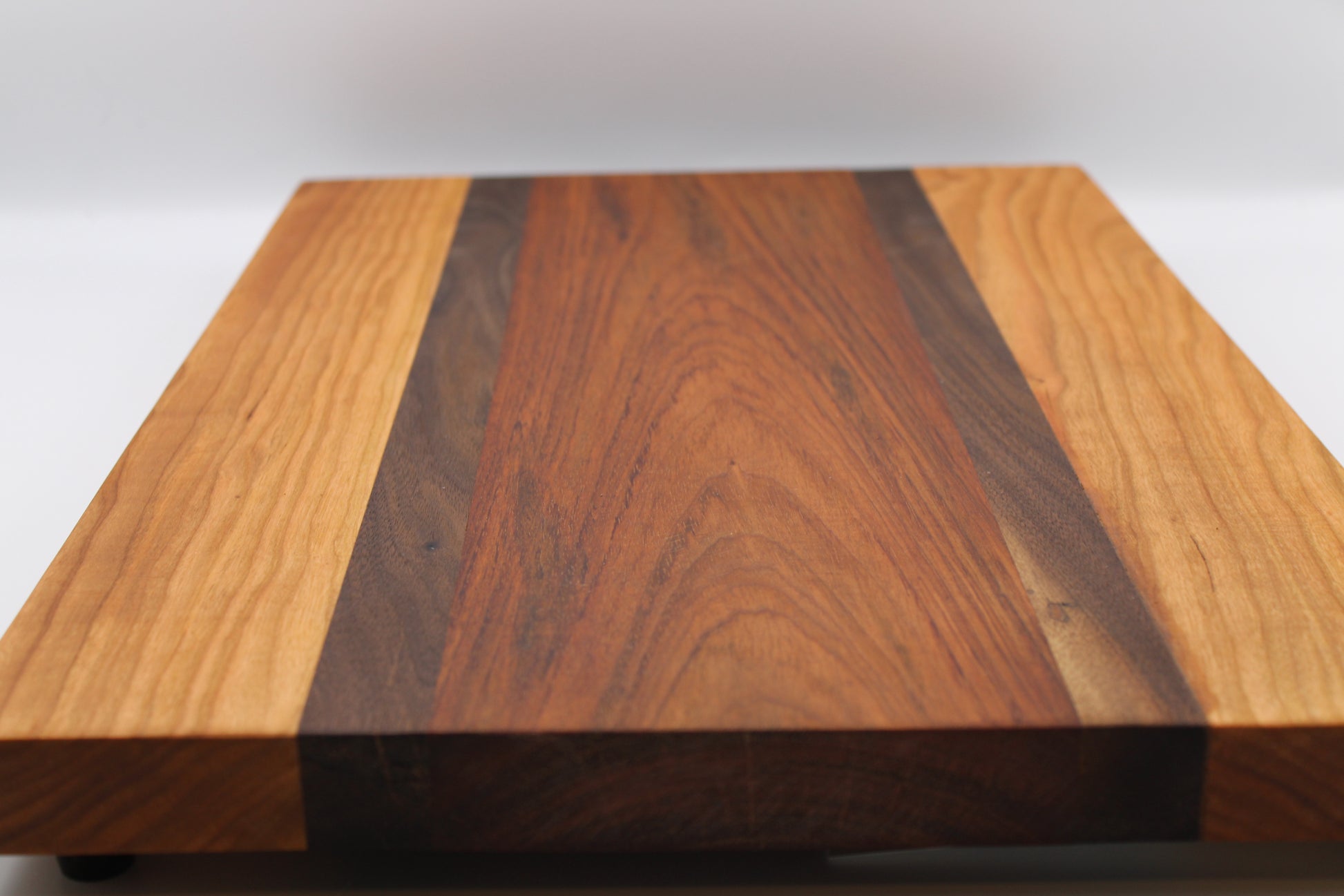 Wooden cutting board with a striped pattern on a white background