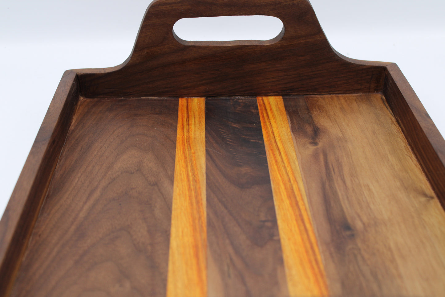 Wooden serving tray with a handle on a white background