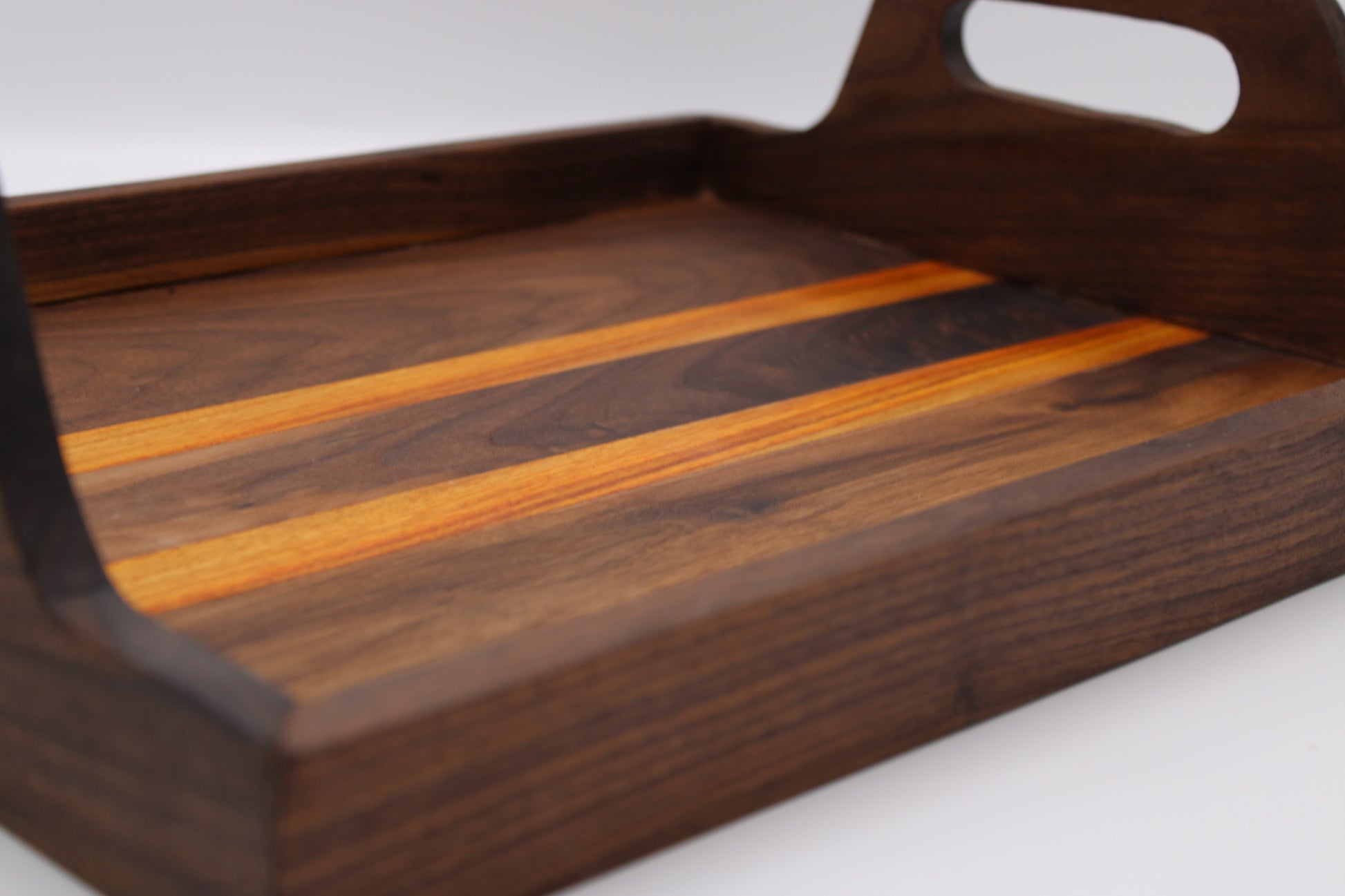 Wooden tray with a striped pattern on a white background