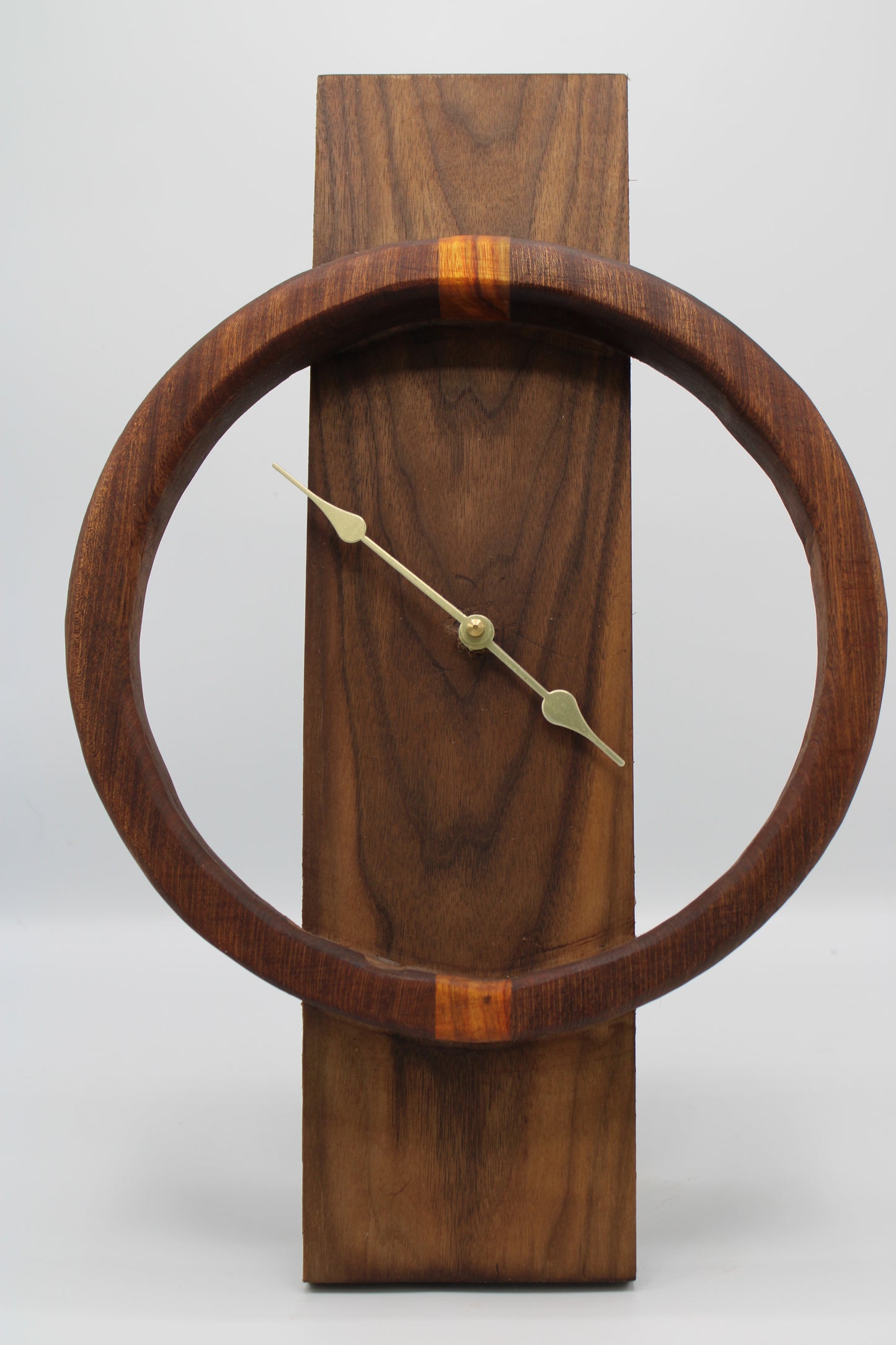Wooden wall clock with a circular design on a white background