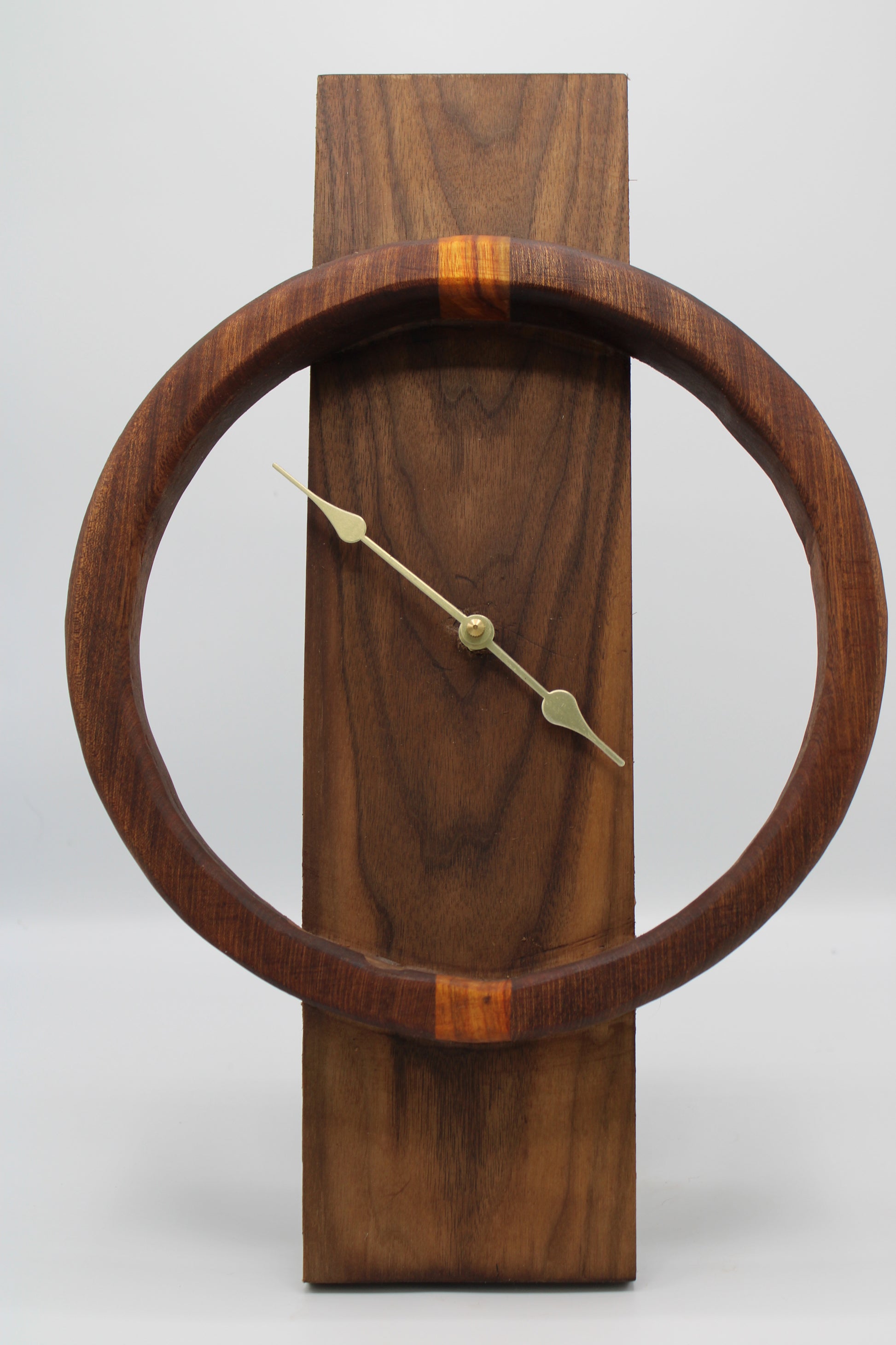 Wooden wall clock with a circular design on a white background