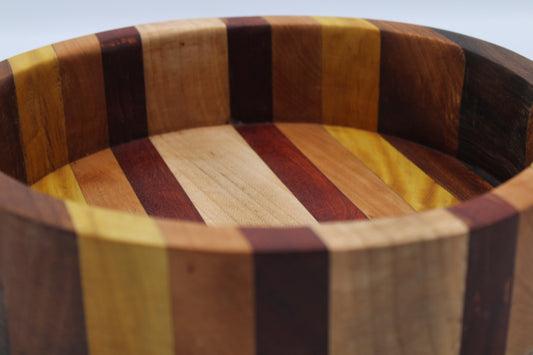Wooden bowl with multicolored striped pattern