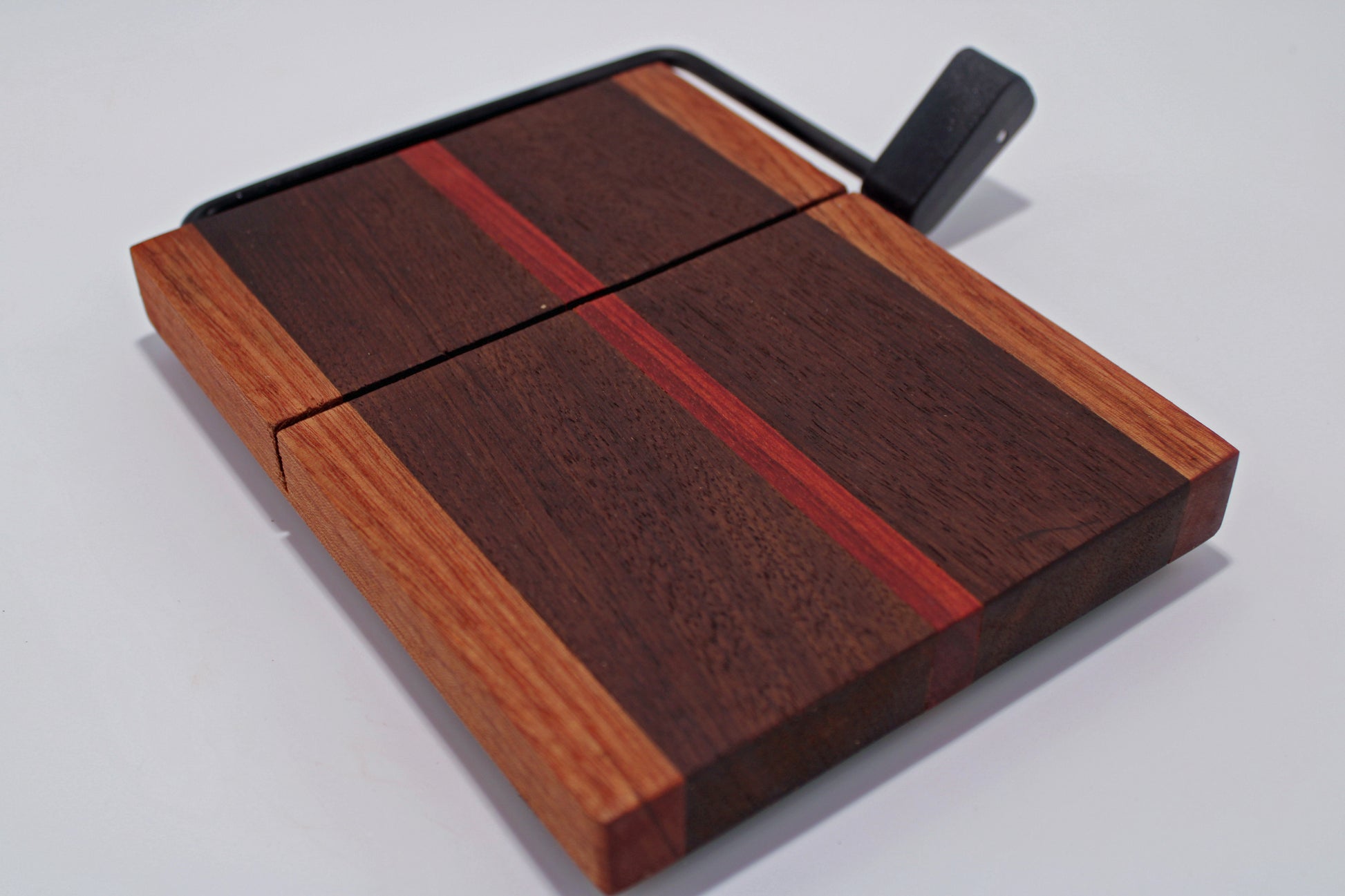 Wooden cutting board with a knife on a white background