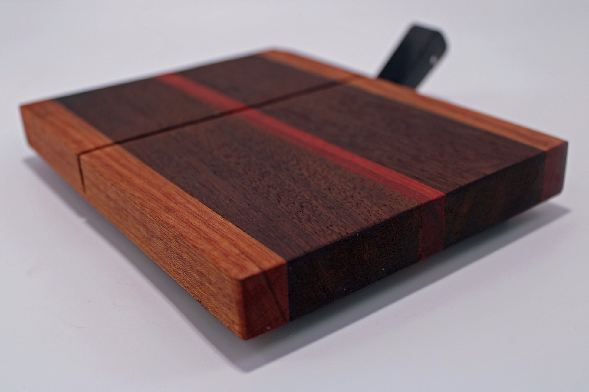 Wooden cutting board with a knife on a white background