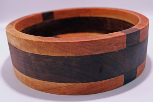 Wooden bowl with a multicolored pattern on a white background
