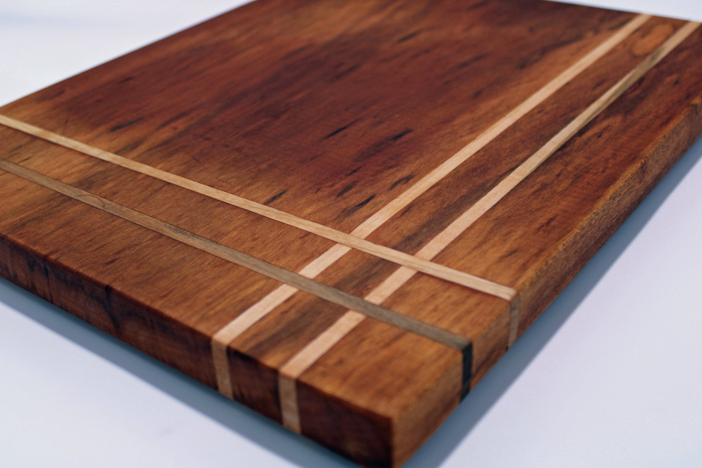 Wooden cutting board with a striped pattern on a white background