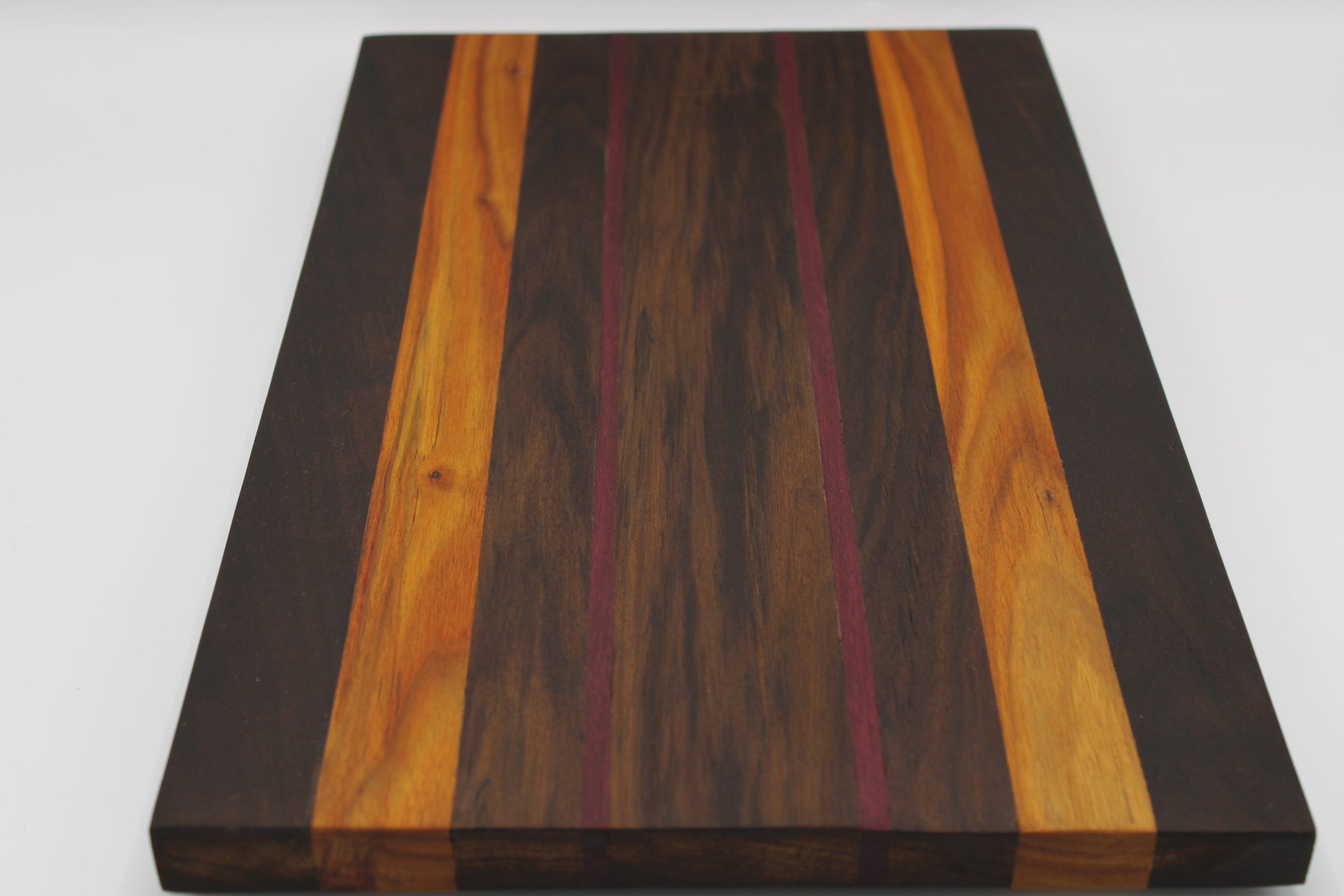 Wooden cutting board with striped pattern on a white background
