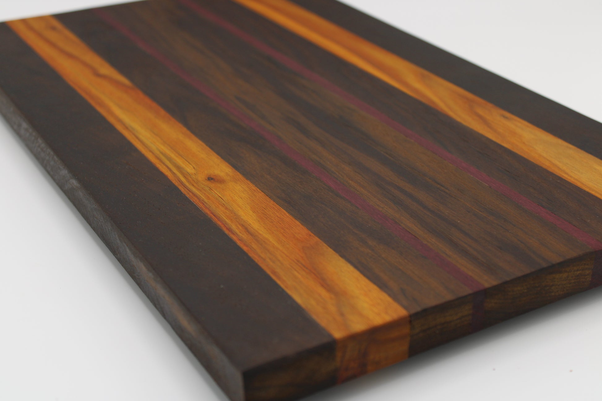 Wooden cutting board with a striped pattern on a white background