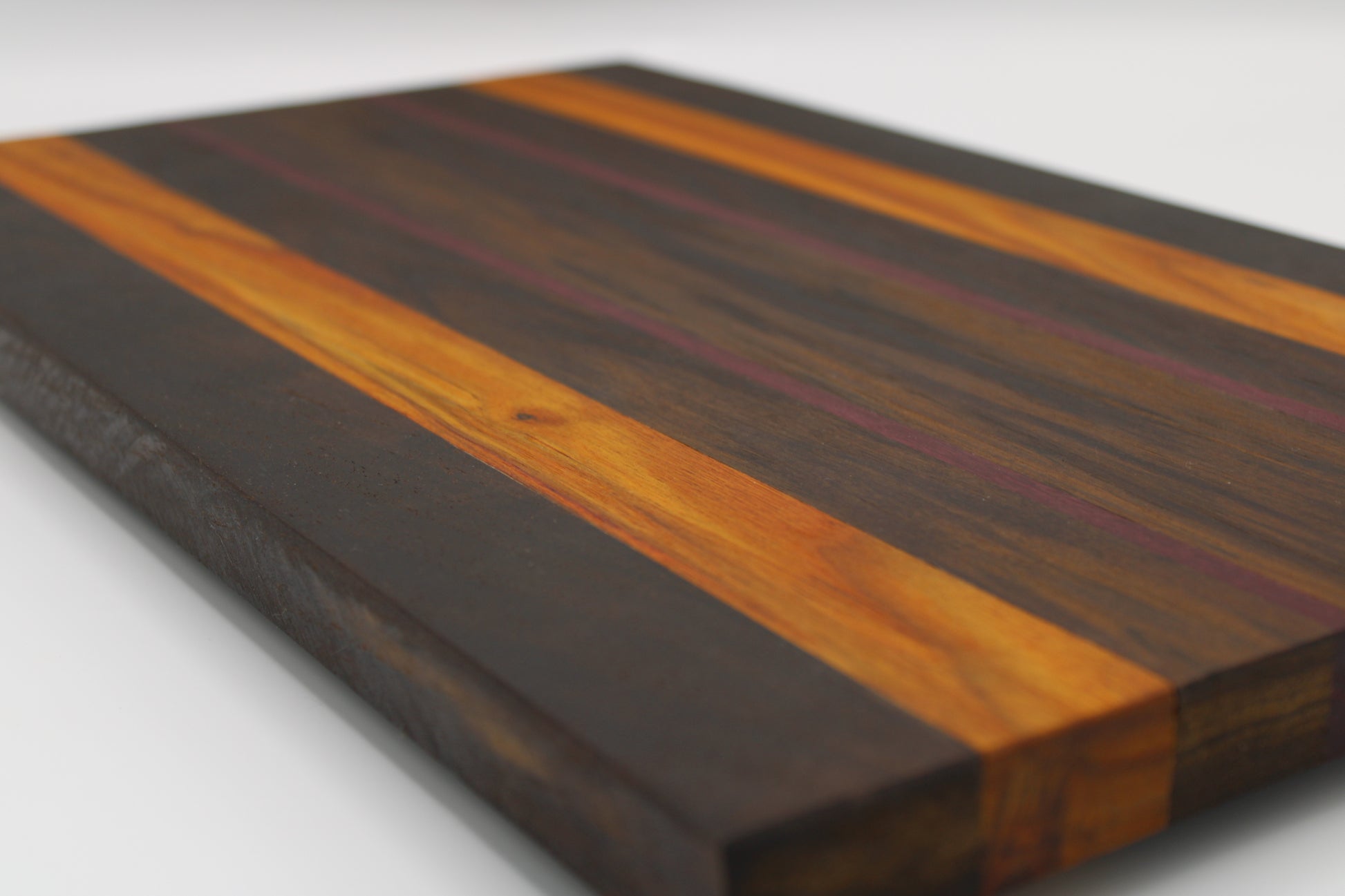 Wooden cutting board with striped pattern on a white background