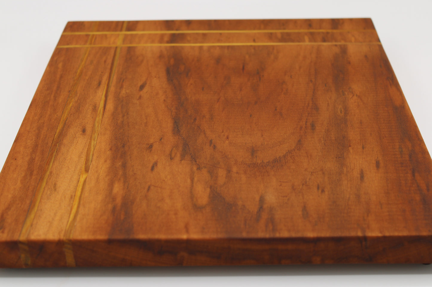 Wood cutting board with inlaid stripes