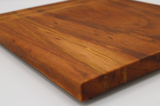 Wood cutting board with inlaid stripes