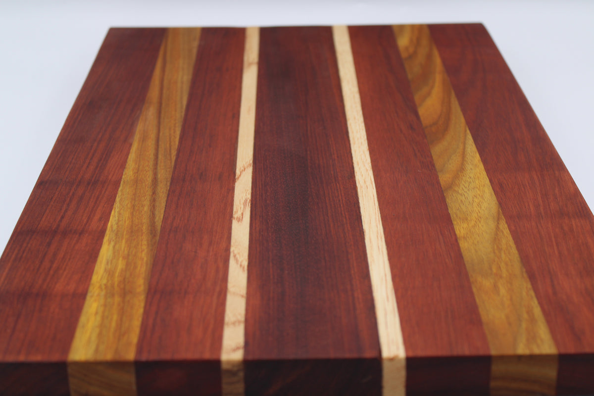 Wooden cutting board with a striped pattern on a white background