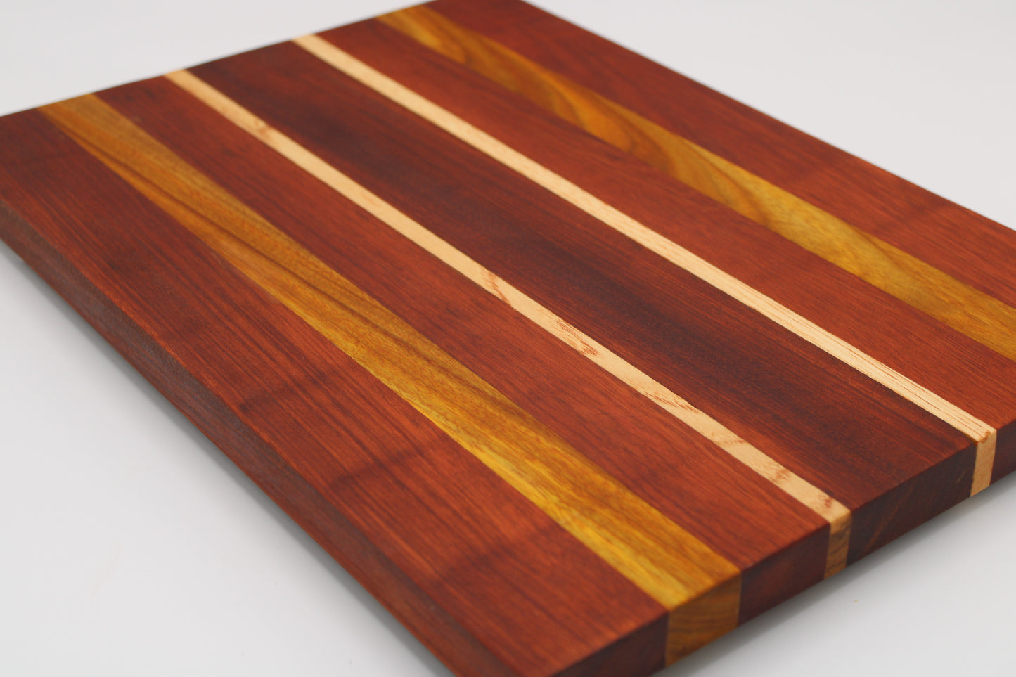 Wooden cutting board with striped pattern on a white background