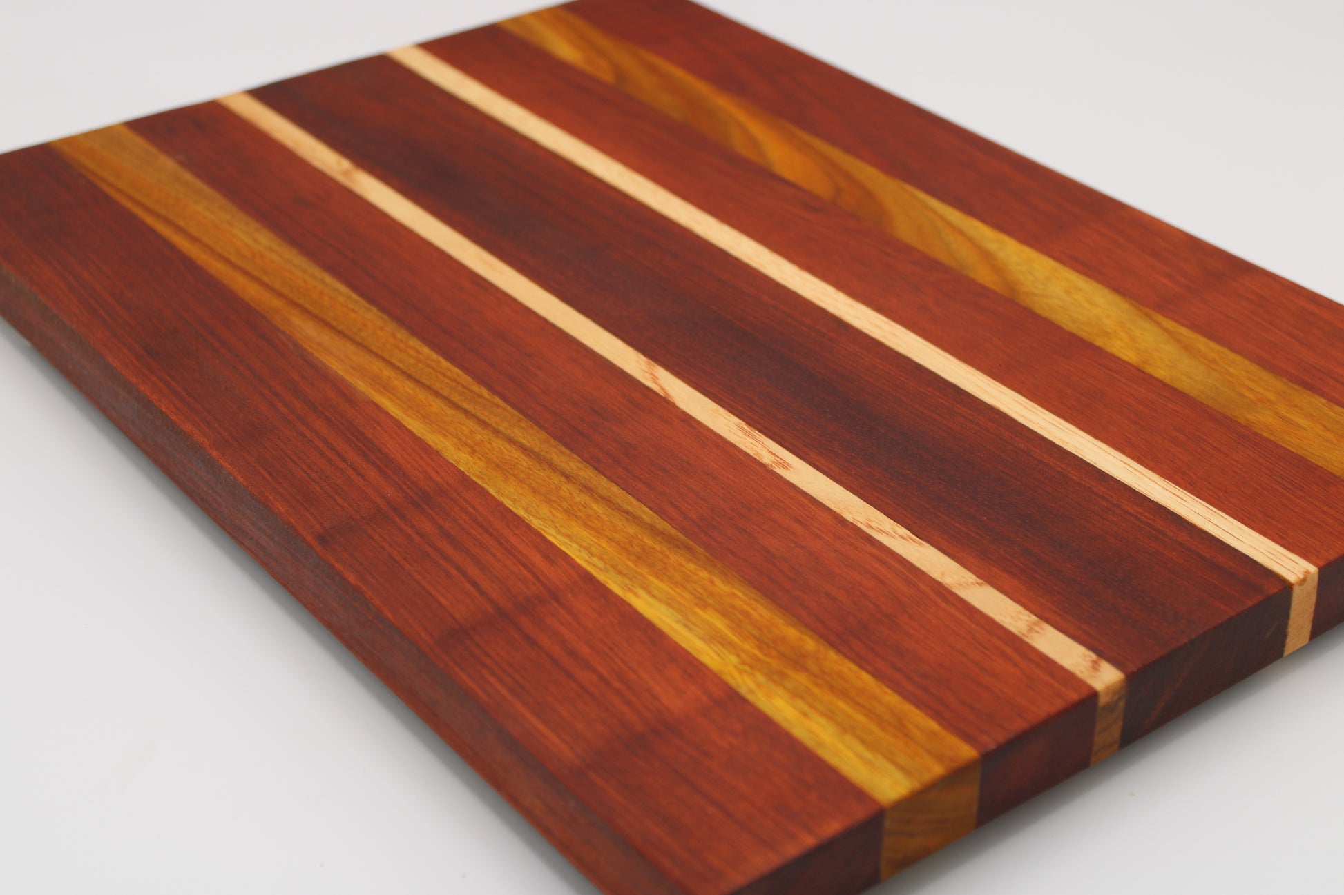 Wooden cutting board with striped pattern on a white background