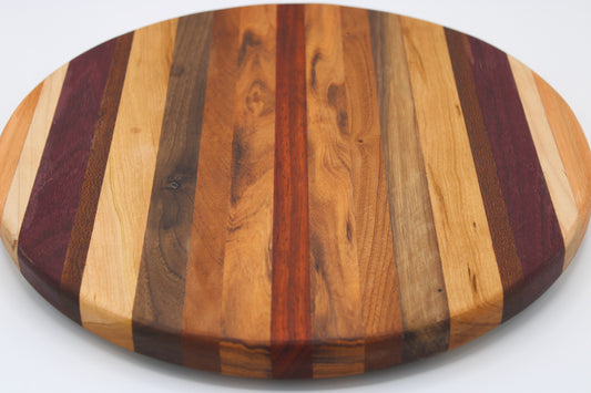 Round wood cutting board will multi color stripes