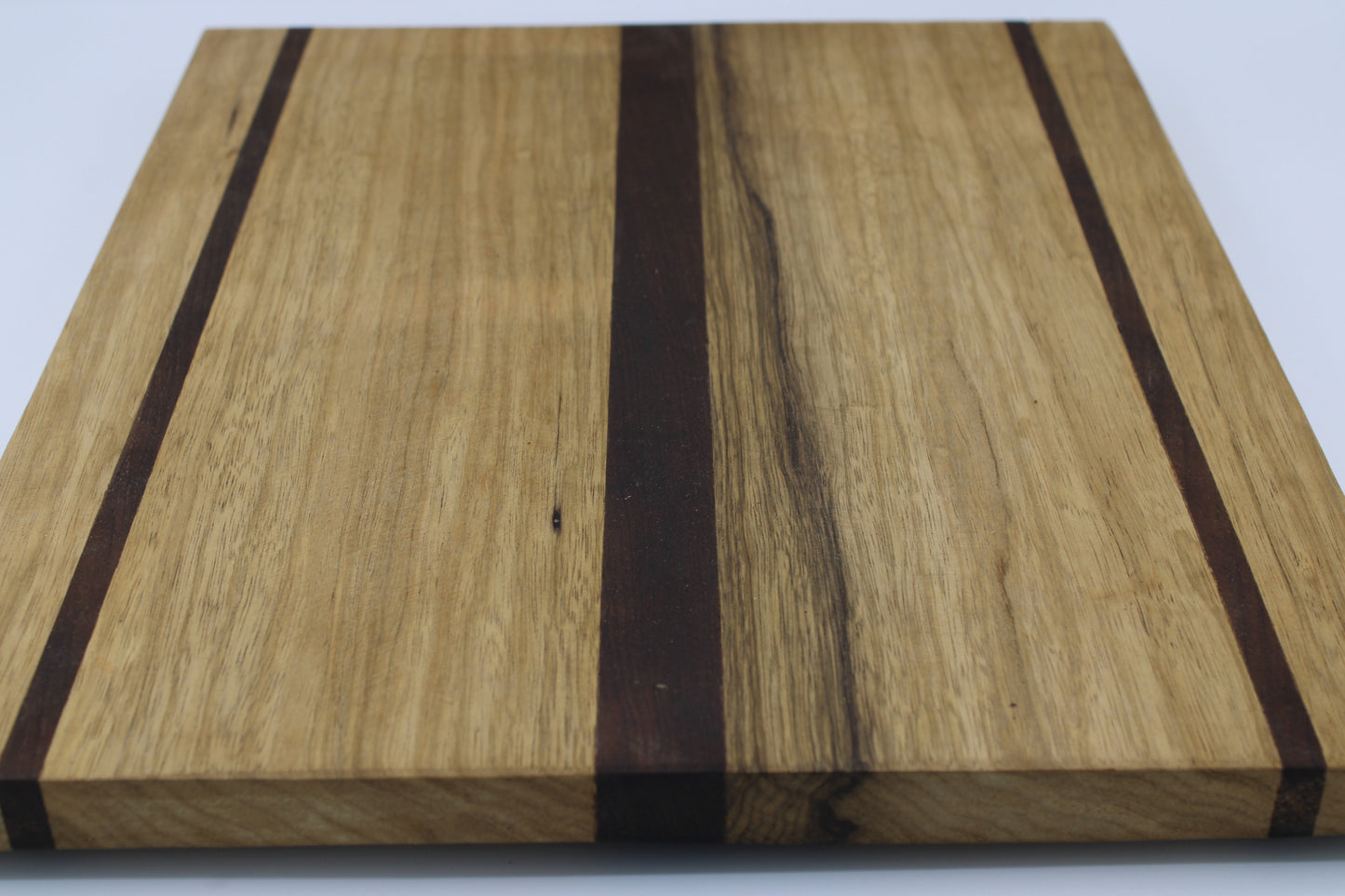 Wood cutting board with light and dark brown stripes