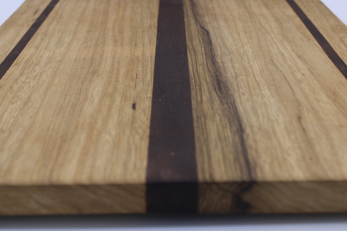 Wood cutting board with light and dark brown stripes