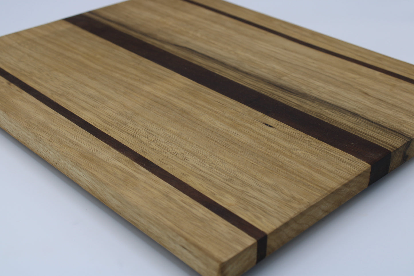 Wood cutting board with light and dark brown stripes