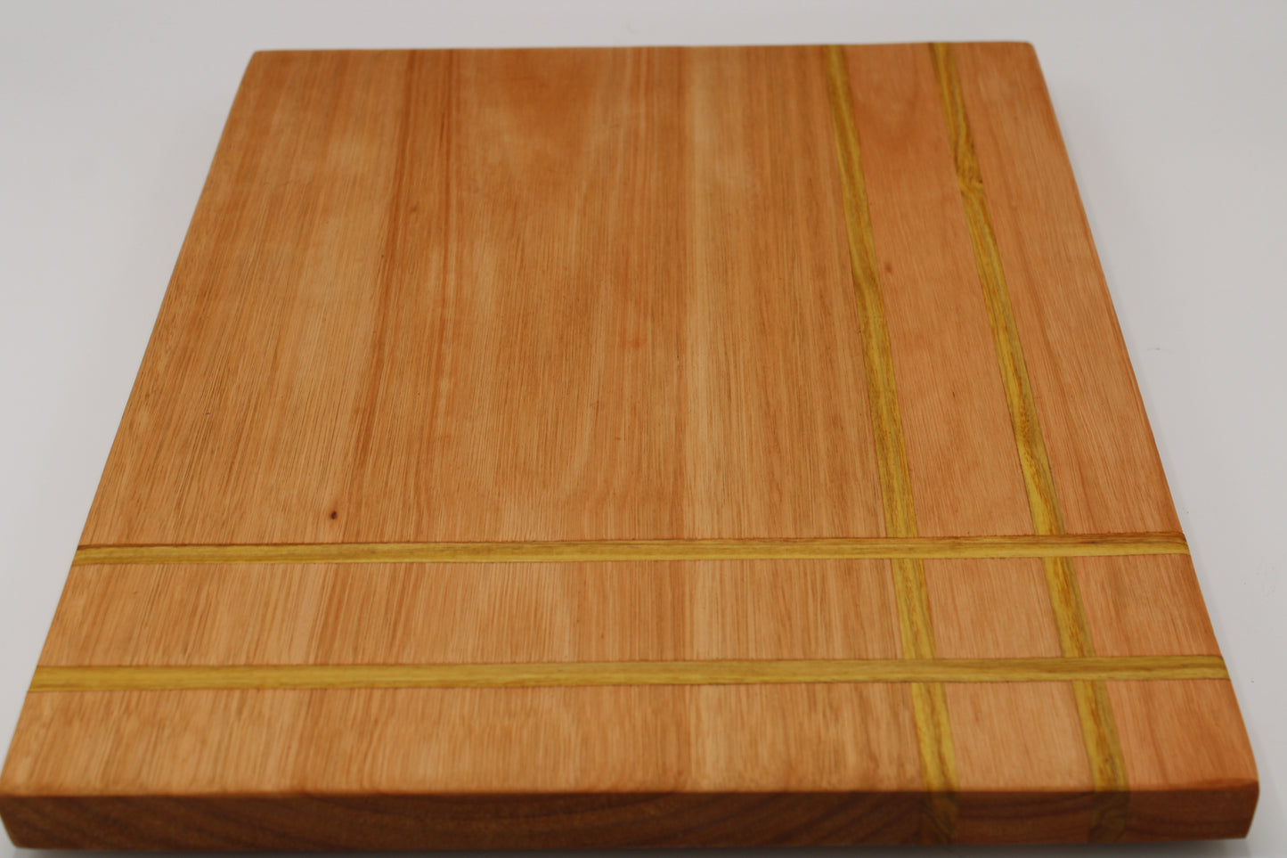 Wood cutting board with corner weave detail