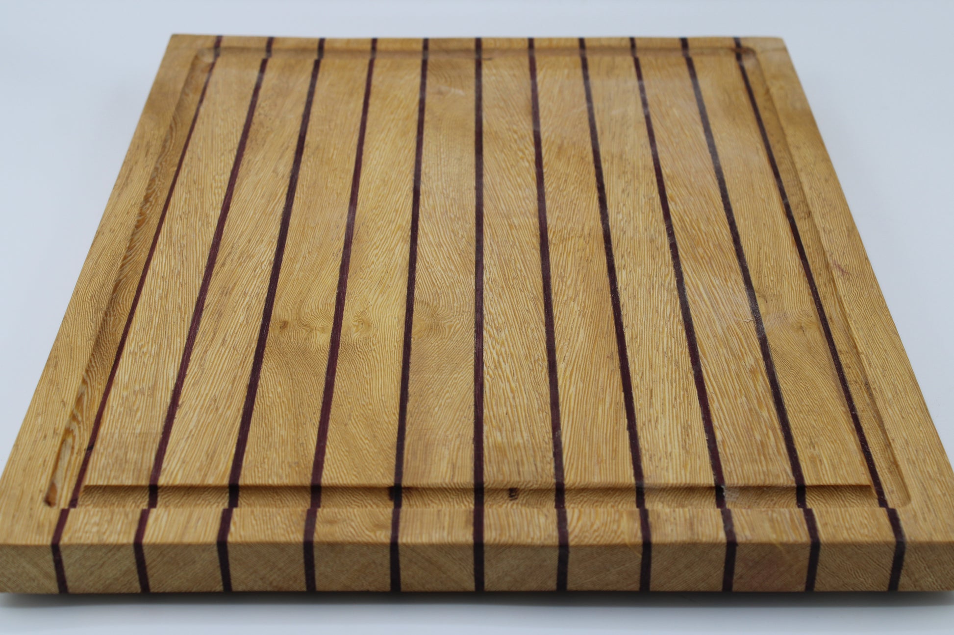 Wood butting board with purple and tan stripes
