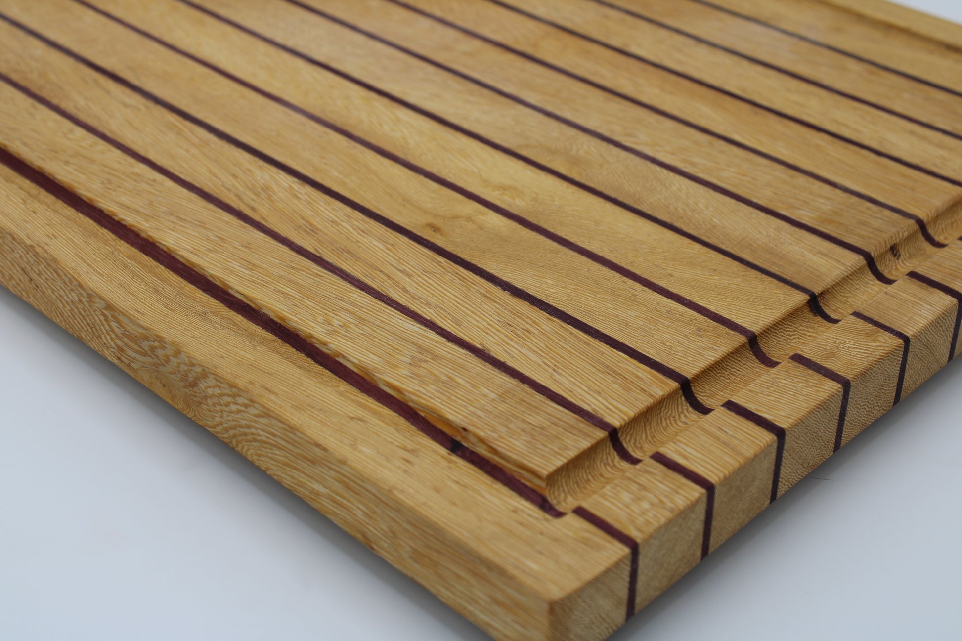 Wood butting board with purple and tan stripes