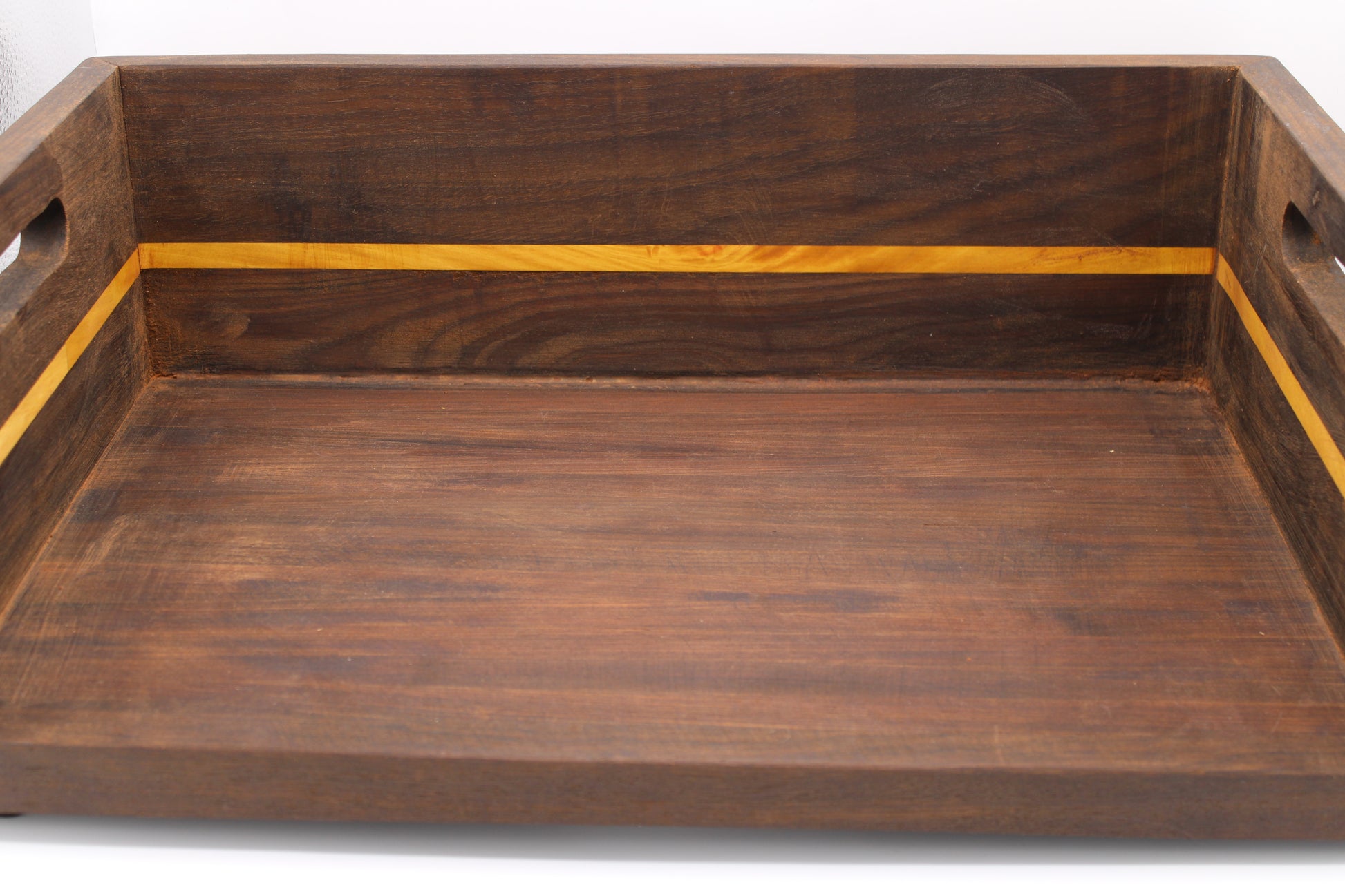 A rectangular wooden serving tray with cutout handles on the sides, featuring a dark brown wood finish and a contrasting light yellow inlay stripe along the inner rim.