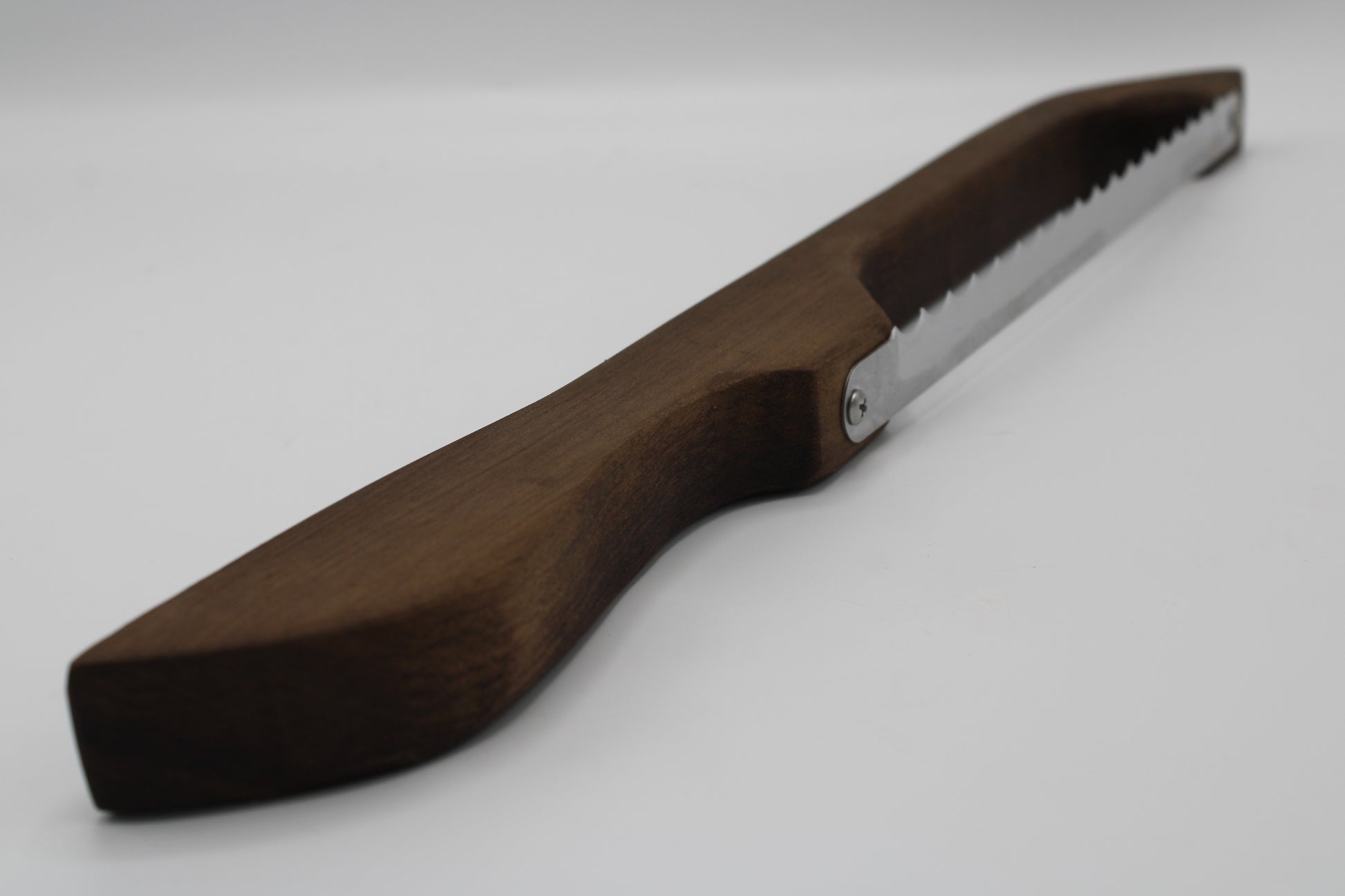 A hand saw with a dark brown wooden handle and a silver metal blade, shown on a plain light gray background.