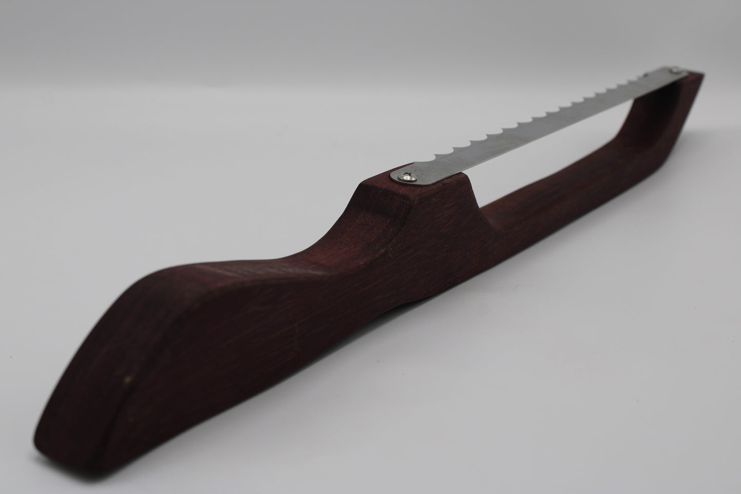 A hand saw with a dark reddish-brown wooden handle and a silver metal blade, shown on a light gray background.