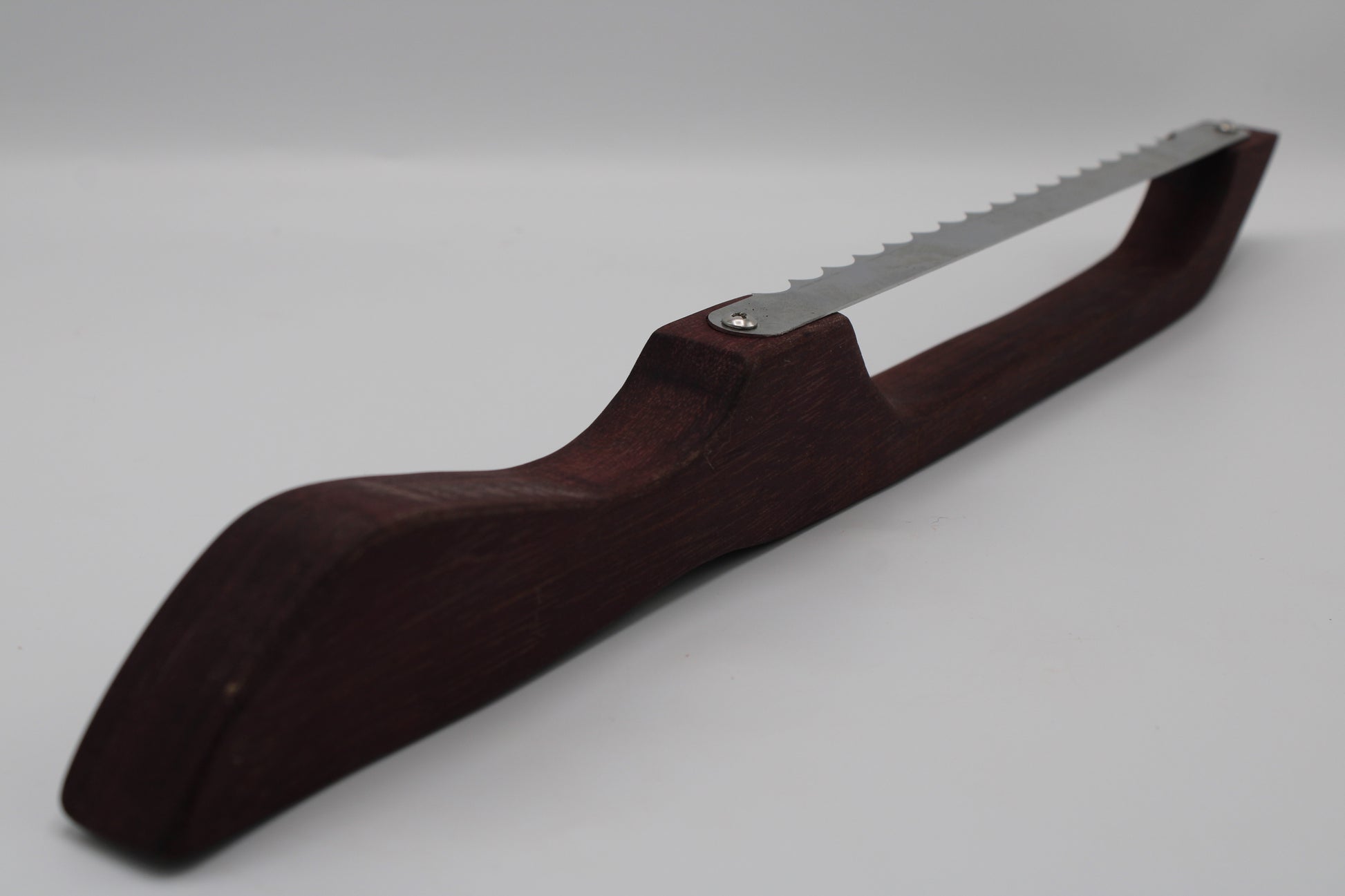 A hand saw with a dark reddish-brown wooden handle and a silver metal blade, shown on a light gray background.